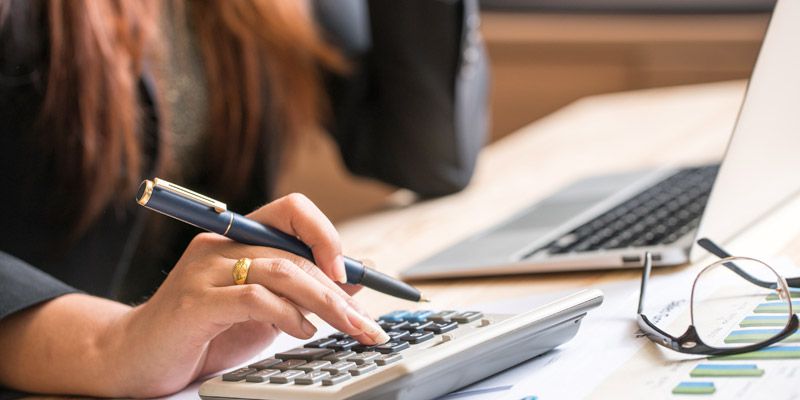 Close up of female accountant or banker making calculations