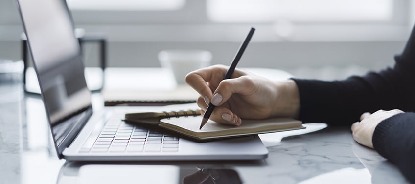 A designer contemplating the design elements of a real estate agent website.