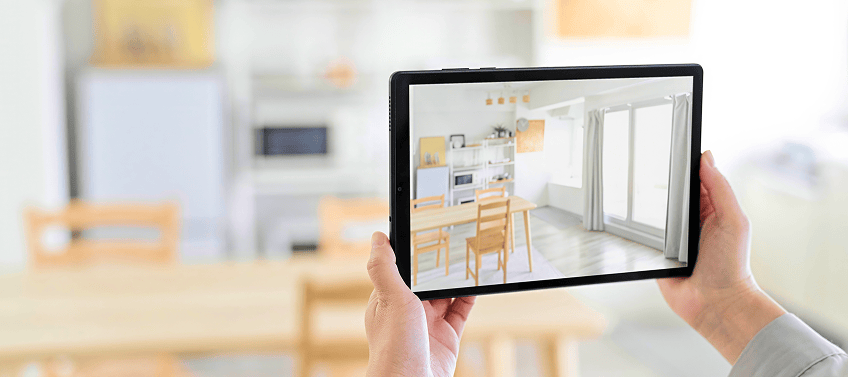 A real estate agent uses a tablet to stage a home virtually.