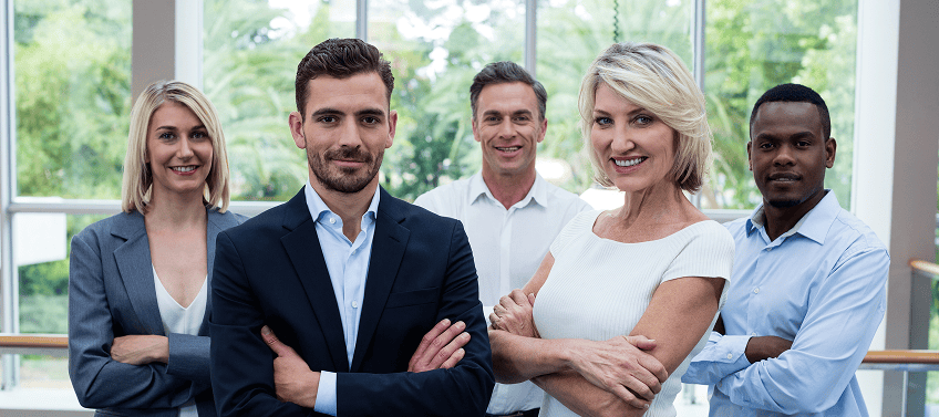 A diverse group of real estate agents confidently smiling at the camera.
