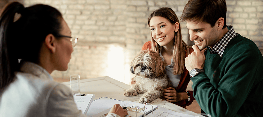 A real estate agent in conversation with two customers.